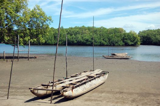 Timber canoe ar river coast, Papua New Guinea