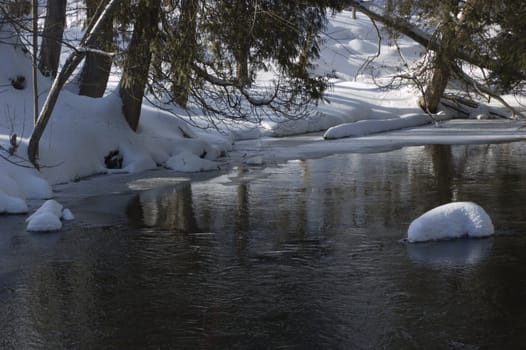 Snowy creek with snow bumps. Hillton Falls.