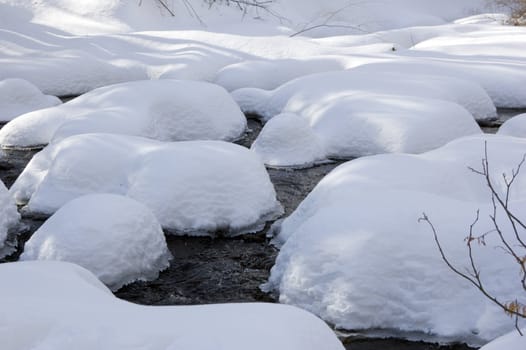 Snowy creek with snow bumps