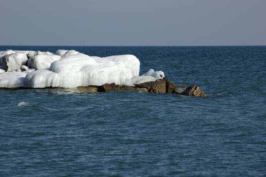 Ice island in Ontario lake in winter evening.