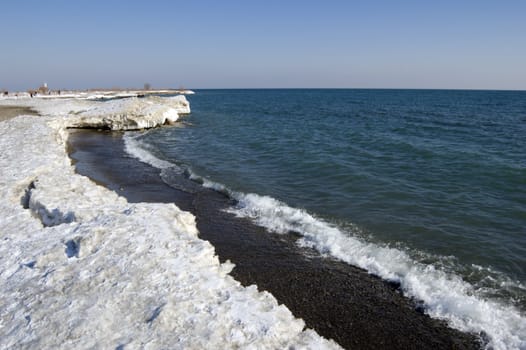 Ice on shote of Ontario lake in winter evening.