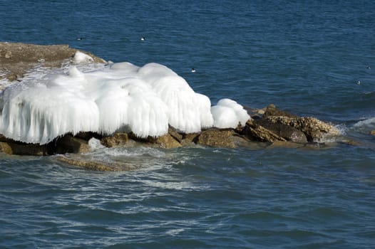 Ice island in Ontario lake in winter evening.