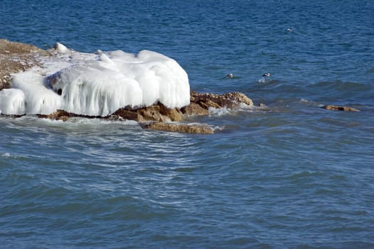 Ice island in Ontario lake in winter evening.