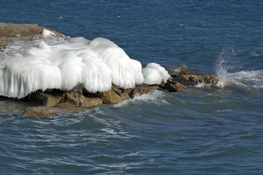 Ice island in Ontario lake in winter evening.