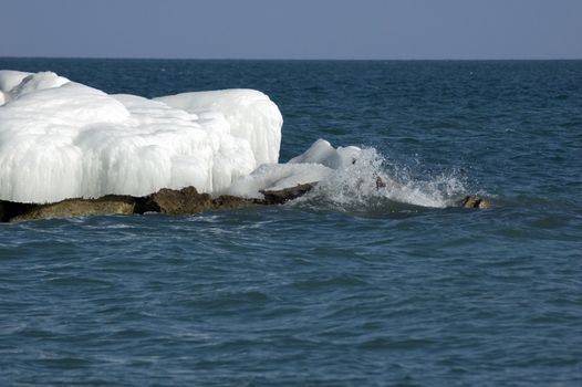 Ice island in Ontario lake in winter evening.