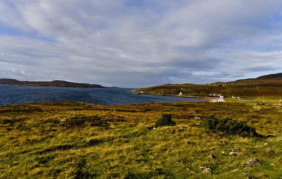 rural scottish scene at the coast with wetland and cloudy sky