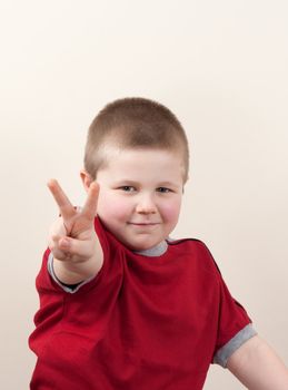 portrait of little boy in red shirt