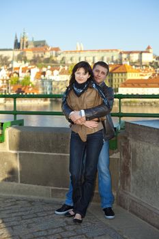 young couple on the Charles Bridge on the skyline