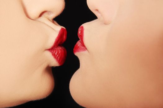 Close up of pair women mouths kissing