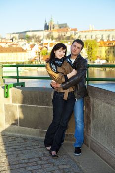 young couple on the Charles Bridge on the skyline