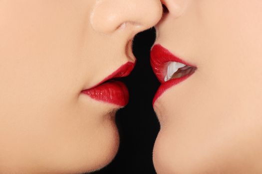 Close up of pair women mouths kissing