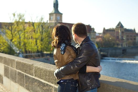 young couple on the Charles Bridge on the skyline