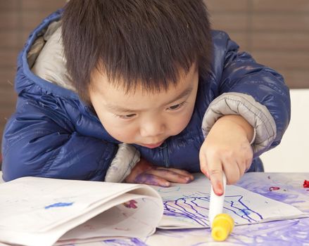 a cute baby is painting