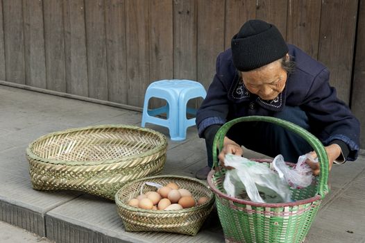 woman is selling eggs in a town