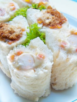 Sandwich sushi rolls salad tuna, ham cheese and dried shredded pork on dish