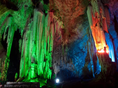 Stalactite wall illuminated with color light in Tham Khao Bin cave, Ratchaburi, Thailand