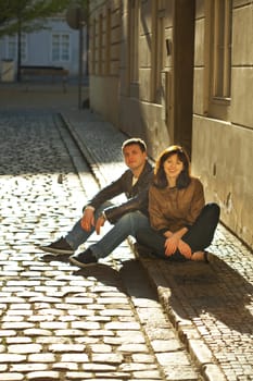 love couple sitting on the pavement