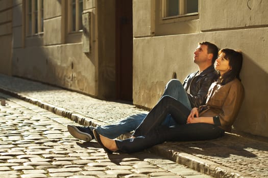 love couple sitting on the pavement