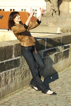 beautiful young woman standing on the bridge