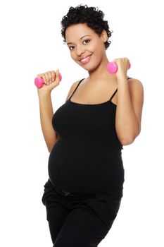 Portrait of a young smiling pregnant woman holding weights in her hands, isolated on a white background.