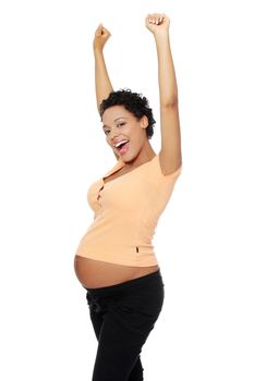 Site view of a smiling young pregnant woman bursting out with happiness, isolated on a white background.