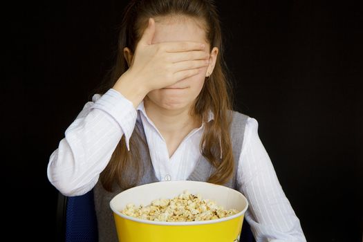 girl in a movie theater closes her eyes