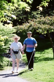 Blind couple walking in the park together on a blind date.