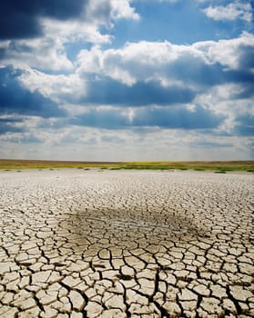 cracked earth under dramatic sky