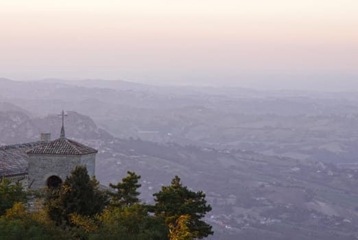 The bell tower of the Basilica of San Marino, over looking the country side at dusk. 