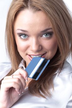 Young and beautiful girl with a credit card in the hands of blue