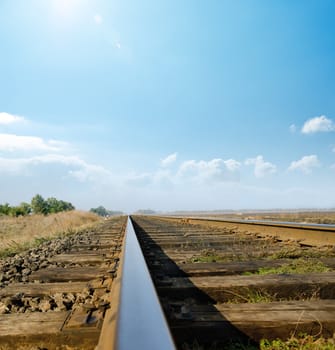 railway to horizon under sunny sky