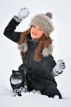 Young Beautiful Woman play in winter time