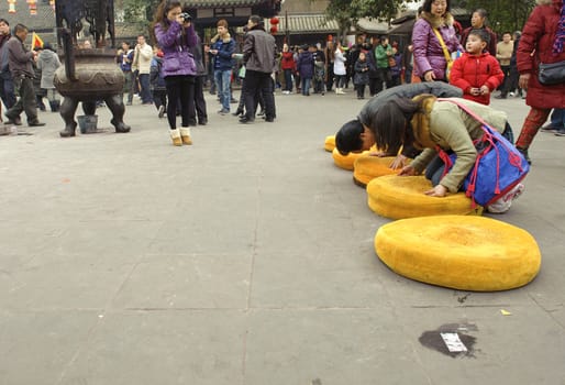 CHENGDU - FEB 5: People praying to Buddha in temple during chinese new year on Feb 5, 2011 in Chengdu, China.Many people want to relieve their worries and difficulties by burning incense and praying to Buddha during festivals.It's part of the important traditional custom in China.