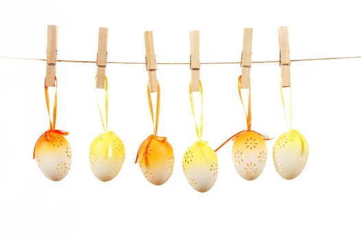 hanged bright color easter eggs with bows on white background