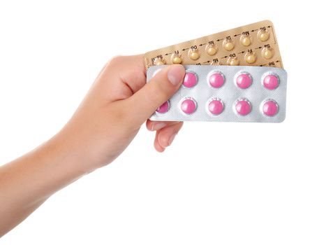 tablets (Birth Control Pills) in the hand, isolated on white background 