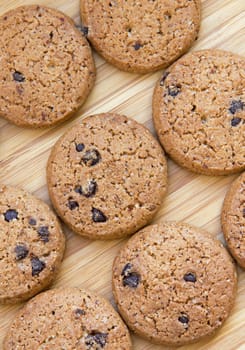 Delicious chocolate chip cookies on wooden background