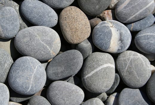 Grey pebbles on the beach can use as background 
