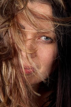 Close-up of young woman with hair all over her face