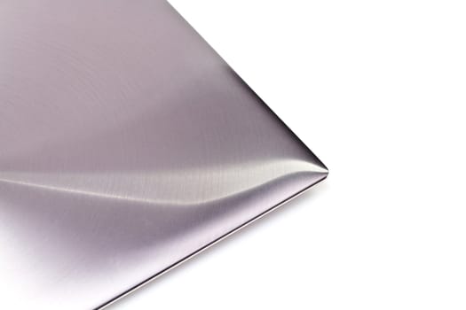 top view of a modern metal-lid laptop on white background for abstract background