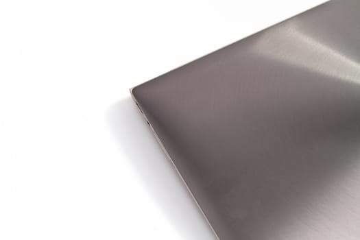 top view of a modern metal-lid laptop on white background for abstract background
