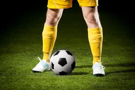 Close up of a soccer ball and a feet of a soccer player