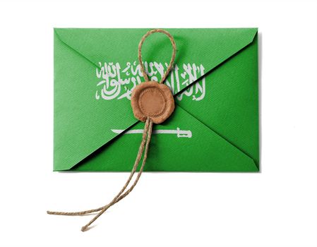 The Saudi Arabia flag on the mail envelope. Isolated on white.