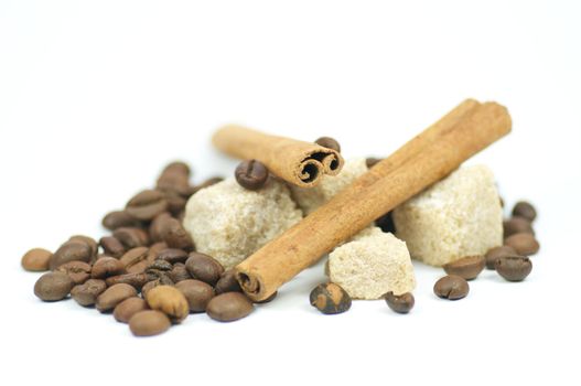 Cinnamon sticks, brown sugar and coffee grains isolated on white background