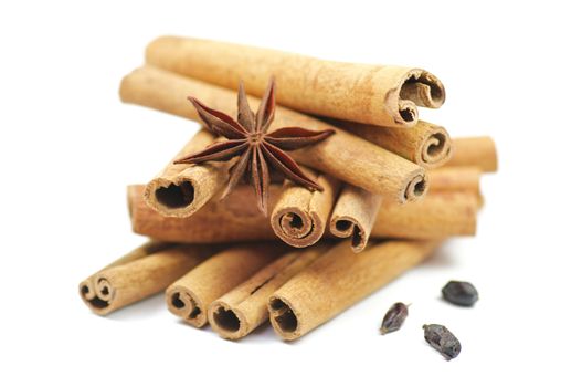 Cinnamon sticks and anise with barberry isolated on white background