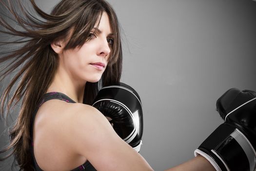 A sexy young and fit female fighter posing in combat poses