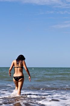 Girl on a deserted beach in a bay in Ecuador