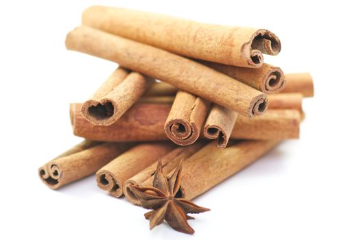 Cinnamon sticks and anise on white background