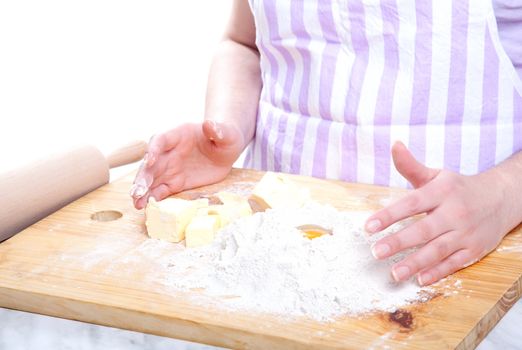 female hands in flour closeup kneading dough