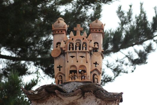 Typical terracotta sculpture of a church made by artisans of the village of Quinua, Peru
