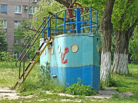 Old rusty decorative ship on a children's playground.